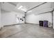 Spacious two-car garage featuring bright lighting and concrete floors with interior access at 3008 Blake St, Denver, CO 80205