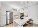 Modern kitchen featuring stainless steel appliances, quartz countertops and bar stool seating at 3008 Blake St, Denver, CO 80205