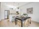 Bright kitchen and dining area featuring stainless steel appliances, sleek white cabinets, and bar seating at 3008 Blake St, Denver, CO 80205