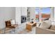 Cozy living room with a modern fireplace, bright window, stylish furniture, and neutral color palette at 3008 Blake St, Denver, CO 80205