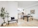 Open-concept living space showcasing hardwood floors, dining area, and a modern kitchen with white cabinets at 3008 Blake St, Denver, CO 80205