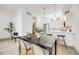 Open-concept area featuring a sleek kitchen with bar seating, dining area and bright light hardwood floors at 3008 Blake St, Denver, CO 80205