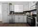 Bright kitchen with white cabinets, hexagon backsplash, and wood flooring at 8956 Fox Dr # 8-101, Thornton, CO 80260