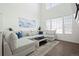 Bright living room with a sectional sofa and large windows at 8956 Fox Dr # 8-101, Thornton, CO 80260