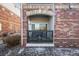 Small patio with brick walls and a sliding glass door at 8956 Fox Dr # 8-101, Thornton, CO 80260