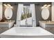 Modern bathroom featuring a soaking tub under a window with a wooded view at 6087 Highway 9, Breckenridge, CO 80424