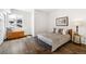 Bedroom with hardwood floors, a large window, and a comfortable bed with decorative pillows at 6087 Highway 9, Breckenridge, CO 80424