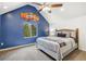 Bedroom with blue accent wall, vaulted ceiling, and natural light at 6087 Highway 9, Breckenridge, CO 80424