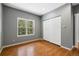 Neutral bedroom with hardwood floors, a large window, and a spacious closet at 6087 Highway 9, Breckenridge, CO 80424