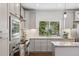 Bright kitchen featuring stainless steel appliances, shaker cabinets, and a large window at 6087 Highway 9, Breckenridge, CO 80424