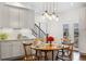 Bright eat-in kitchen featuring stainless steel appliances, shaker cabinets, and a stylish light fixture at 6087 Highway 9, Breckenridge, CO 80424