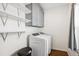 Laundry room with modern washer and dryer, overhead cabinets, and shelving at 6087 Highway 9, Breckenridge, CO 80424