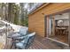 Outdoor patio with table and chairs offering a view of the woods at 6087 Highway 9, Breckenridge, CO 80424