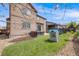 Large backyard featuring a grassy lawn, patio seating, and playhouse, ideal for outdoor fun and relaxation at 12678 Fisher Ln, Englewood, CO 80112