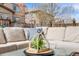 Inviting backyard patio with comfortable cushioned seating, perfect for outdoor relaxation and entertaining guests at 12678 Fisher Ln, Englewood, CO 80112