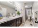 This bathroom has a shower/tub combination and a double vanity with dark cabinets and white sinks at 12678 Fisher Ln, Englewood, CO 80112