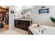 A primary bathroom boasts dual sinks, granite countertops, and a soaking tub, along with a walk-in closet access at 12678 Fisher Ln, Englewood, CO 80112