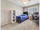 This bedroom has a themed bed and a desk area with a white bookshelf with plenty of natural light at 12678 Fisher Ln, Englewood, CO 80112