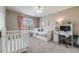 A bedroom is set up with a daybed, a crib, a desk, and pink curtains at 12678 Fisher Ln, Englewood, CO 80112