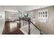 A large bonus room features hard wood floors, plush carpet, and shuttered windows for natural light at 12678 Fisher Ln, Englewood, CO 80112