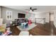 Upstairs bonus room area is carpeted and has a ceiling fan, play area, and railing at 12678 Fisher Ln, Englewood, CO 80112
