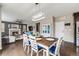 A beautifully staged dining room and fireplace with dark hardwood flooring and a modern light fixture at 12678 Fisher Ln, Englewood, CO 80112