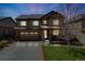 Beautiful home featuring a well-lit exterior, a two-car garage, and a lush front lawn at 12678 Fisher Ln, Englewood, CO 80112