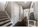 Bright hallway with hardwood floors and staircase, with doors leading to other rooms at 12678 Fisher Ln, Englewood, CO 80112