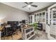 Functional home office with built-in bookshelves, neutral walls, and natural light at 12678 Fisher Ln, Englewood, CO 80112