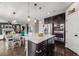 Open-concept kitchen with an island, stainless steel appliances, and dark hardwood flooring throughout at 12678 Fisher Ln, Englewood, CO 80112