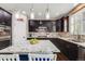 Dark cabinets, granite countertops, mosaic backsplash, and stainless steel appliances in this kitchen at 12678 Fisher Ln, Englewood, CO 80112