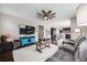 Spacious living room with hardwood floors, a ceiling fan, and open access to the kitchen at 12678 Fisher Ln, Englewood, CO 80112