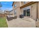 A backyard patio features a seating area with a grill, perfect for entertaining at 12678 Fisher Ln, Englewood, CO 80112