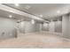 Finished basement space with carpet flooring and ample lighting, perfect for entertainment or recreation at 7099 Cerney Cir, Castle Pines, CO 80108