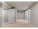Carpeted basement area with multiple doors, providing potential for various uses and storage at 7099 Cerney Cir, Castle Pines, CO 80108