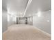 Large basement area with carpet, recessed lighting, and built-in shelving for flexible use at 7099 Cerney Cir, Castle Pines, CO 80108