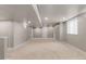 Large basement with neutral walls, plush carpet, and a window for natural light creating a versatile space at 7099 Cerney Cir, Castle Pines, CO 80108