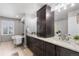 Bathroom with double sink vanity, linen closet, and soaking tub with shutters at 7099 Cerney Cir, Castle Pines, CO 80108