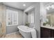 Bathroom featuring soaking tub, walk-in shower, and vanity with great storage at 7099 Cerney Cir, Castle Pines, CO 80108