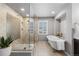 Bright bathroom featuring a glass-enclosed shower and soaking tub for a relaxing retreat at 7099 Cerney Cir, Castle Pines, CO 80108