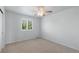 Clean, neutral bedroom with carpet, a ceiling fan, and a window providing natural light at 7099 Cerney Cir, Castle Pines, CO 80108