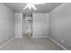 Spacious bedroom with neutral walls, carpet, and a view into an adjoining room at 7099 Cerney Cir, Castle Pines, CO 80108