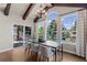 Dining room with exposed wood beams, a chandelier, and large windows with natural light at 7099 Cerney Cir, Castle Pines, CO 80108