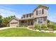 Charming two-story home featuring a stone facade, a welcoming front porch, and manicured landscaping at 7099 Cerney Cir, Castle Pines, CO 80108