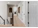 Upstairs hallway with carpet, trimmed doorways, and open staircase at 7099 Cerney Cir, Castle Pines, CO 80108