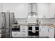 Contemporary kitchen with stainless steel appliances, a subway tile backsplash, and plenty of storage at 7099 Cerney Cir, Castle Pines, CO 80108