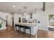 Open-concept kitchen boasts a large island with bar seating and pendant lighting at 7099 Cerney Cir, Castle Pines, CO 80108