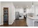 Bright kitchen features white cabinetry, stainless steel appliances, and a stone countertop island at 7099 Cerney Cir, Castle Pines, CO 80108