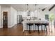 Spacious kitchen features stainless steel appliances, white cabinets, and a central island with stools at 7099 Cerney Cir, Castle Pines, CO 80108
