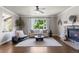 Inviting living room with a fireplace, hardwood floors, and abundant natural light from large windows at 7099 Cerney Cir, Castle Pines, CO 80108